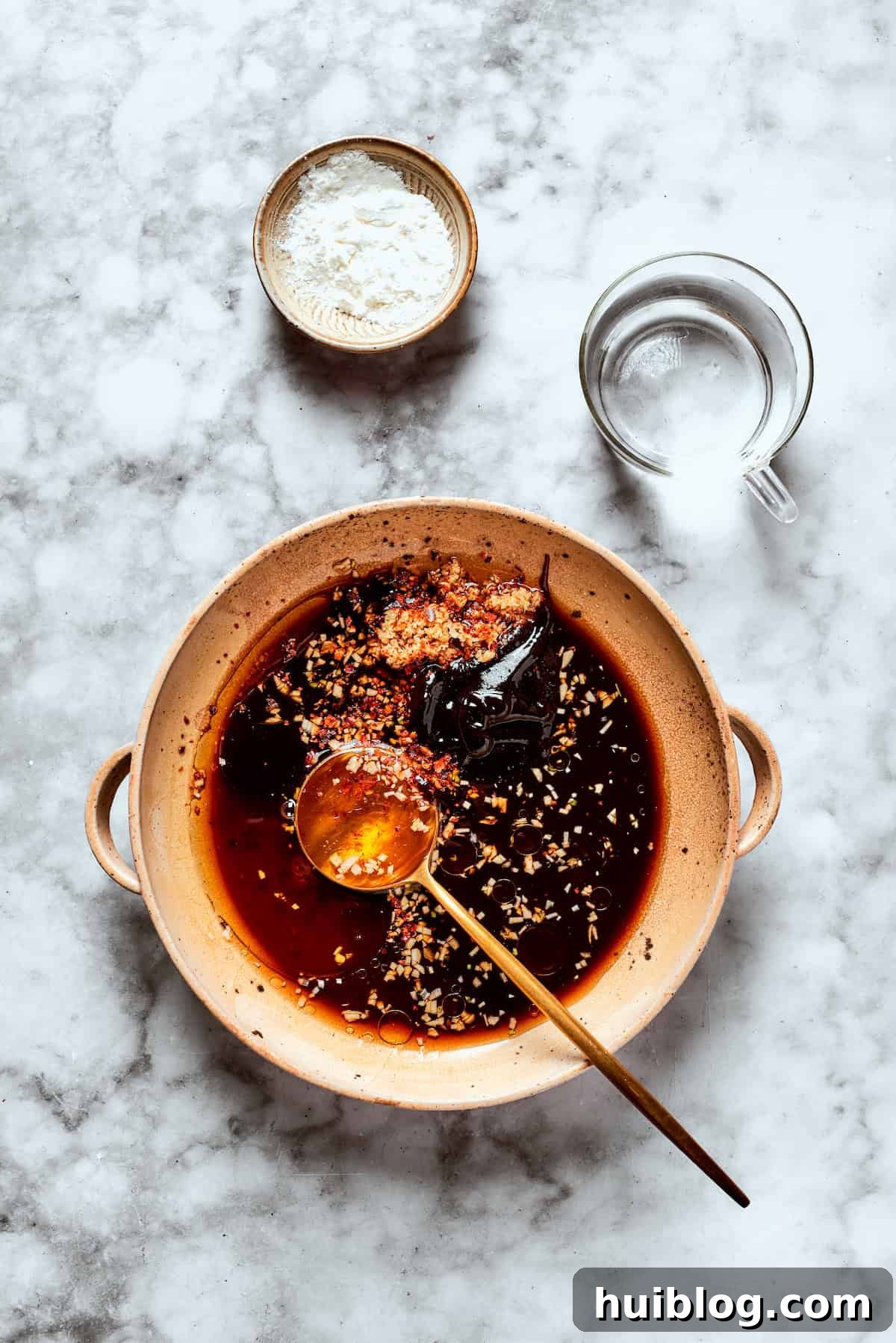 All the liquid and aromatic ingredients for the teriyaki sauce are combined in a mixing bowl.