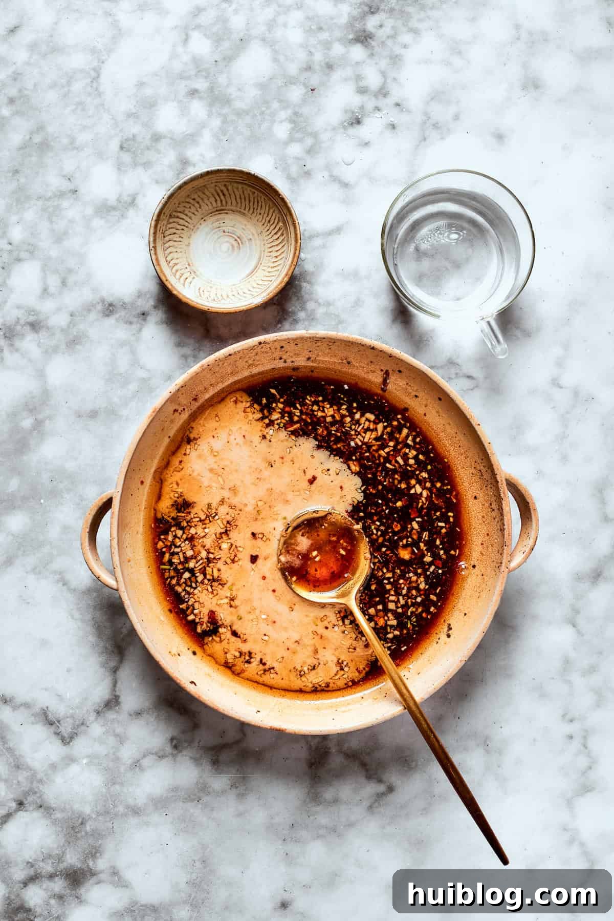 The teriyaki sauce mixture is thoroughly whisked in a bowl until all ingredients are smoothly incorporated.