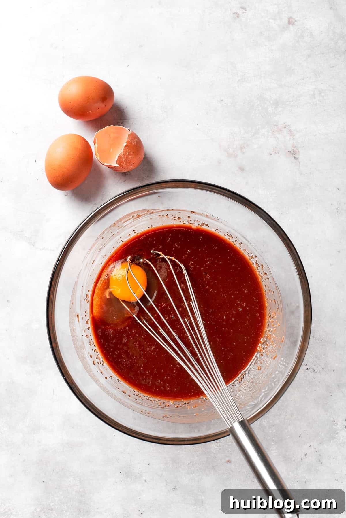 Eggs are whisked into browni batter.