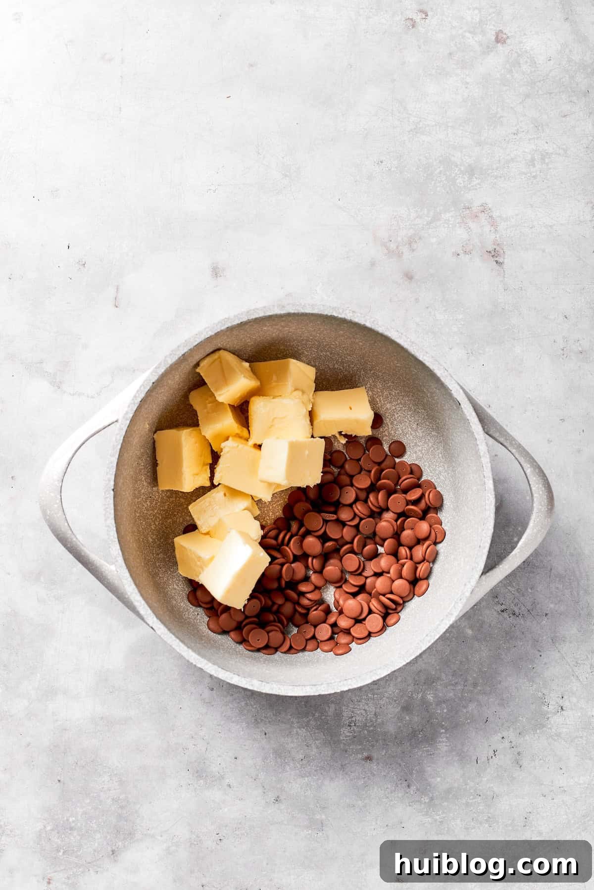Cubes of butter are added to a pot.