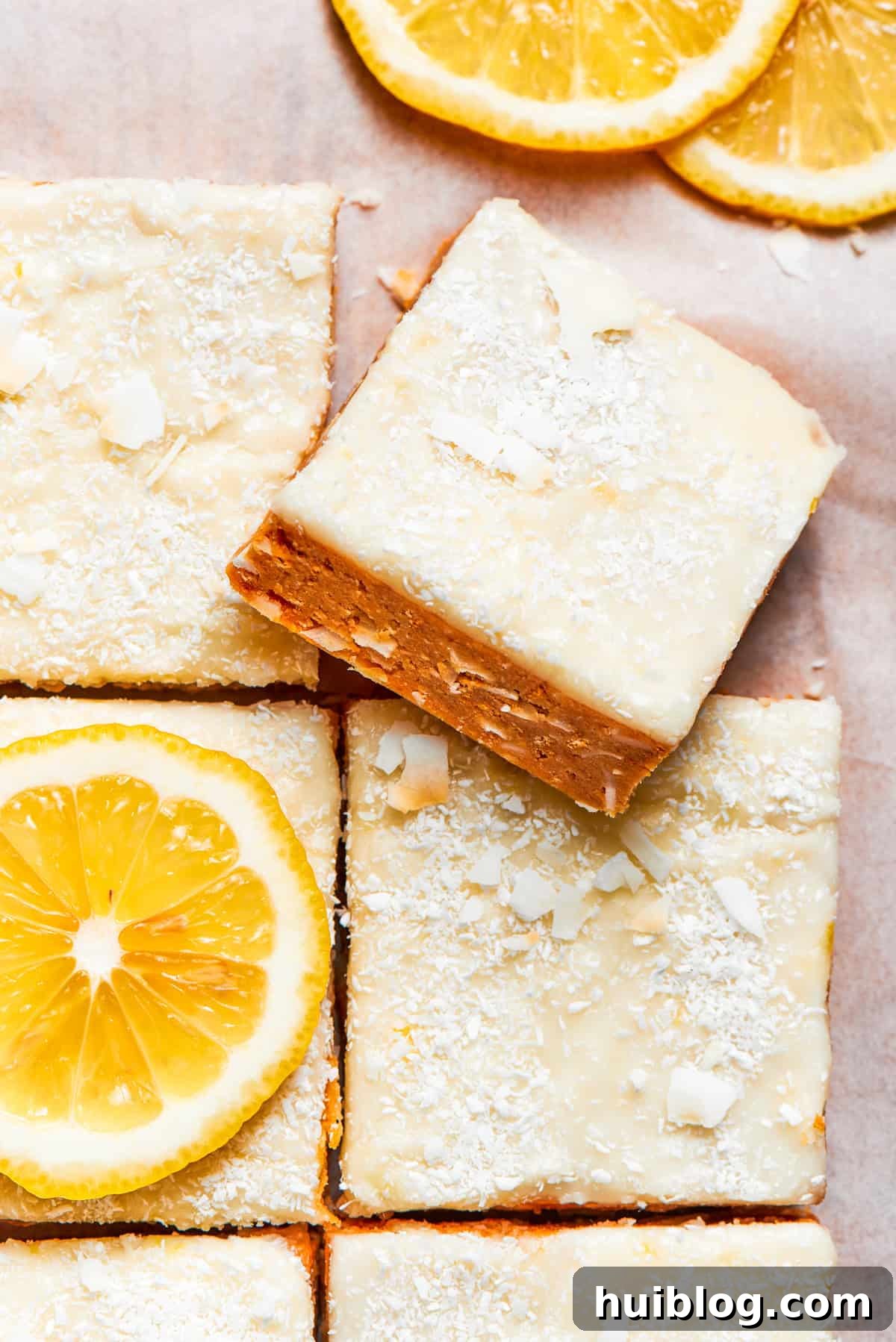 A square of lemon slice on top of other lemon slices, showcasing its delightful texture and vibrant color.