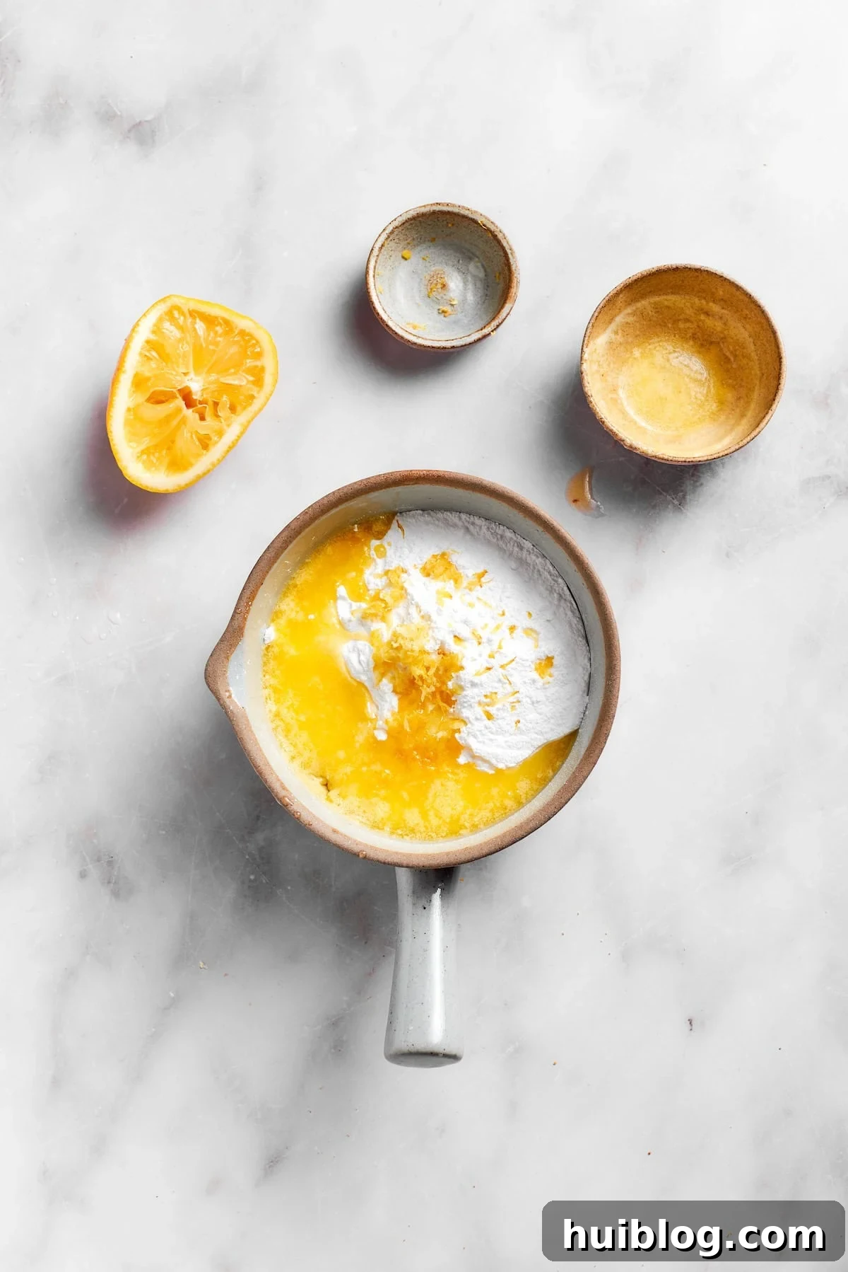 Ingredients for lemon slice frosting: powdered sugar, lemon juice, melted butter, and lemon zest in a bowl.