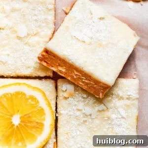 A square of lemon slice on top of other lemon slices, highlighting its vibrant color and tempting layers.