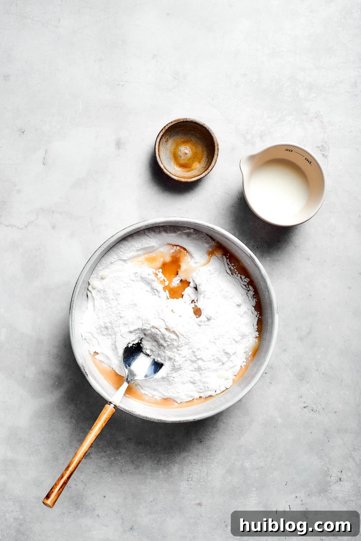 Icing is mixed in a bowl.