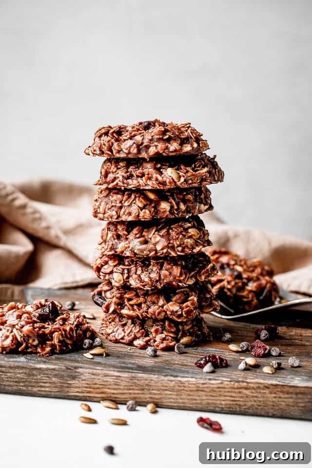 Effortless No-Bake Oatmeal Treats 6 A close-up shot of a neatly stacked column of seven no-bake oatmeal cookies, highlighting their textured surface and enticing ingredients.