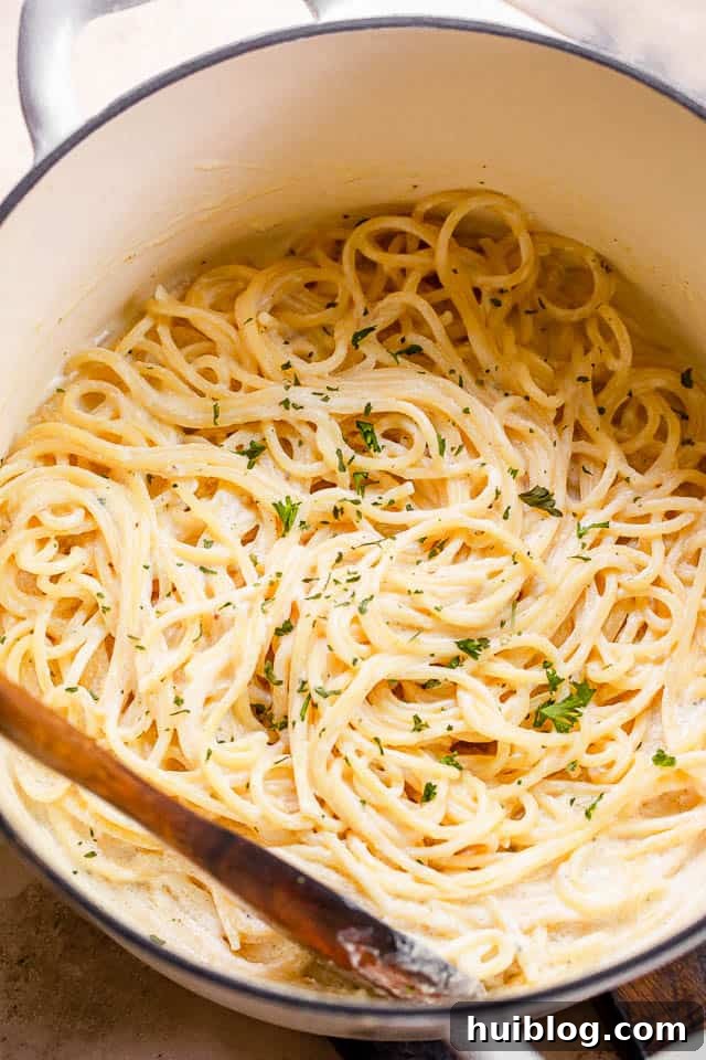 top shot of cream cheese spaghetti in a white pot, ready to serve