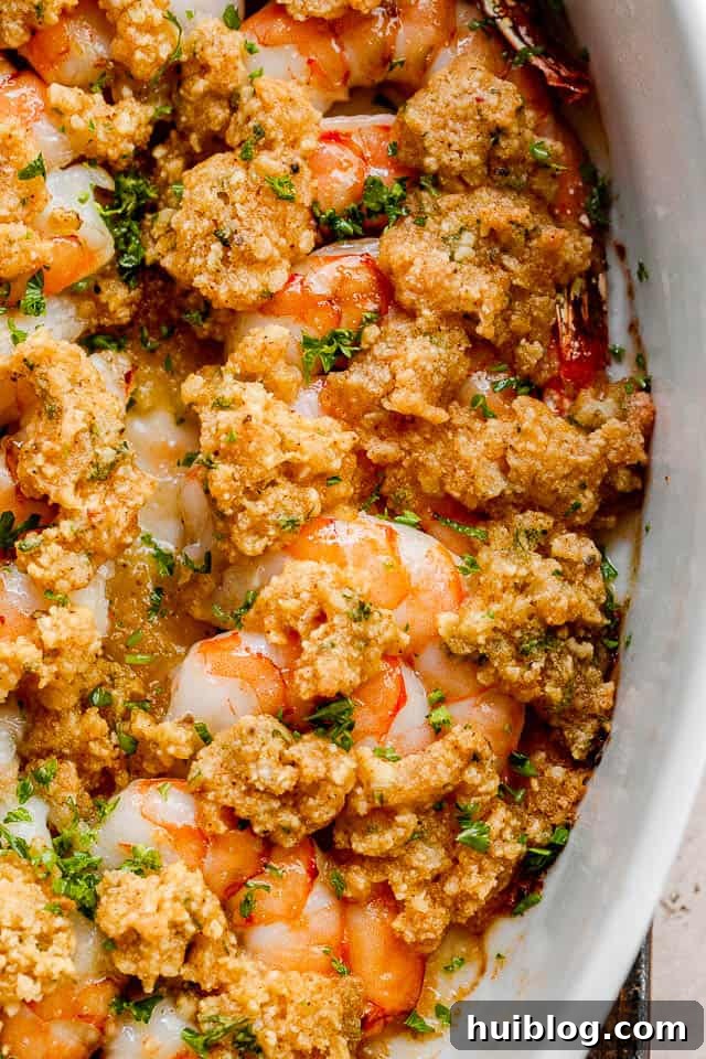 Shrimp Delectables: Garlic Butter Baked and De Jonghe 3 close up shot of garlic butter baked shrimp in a white dish.