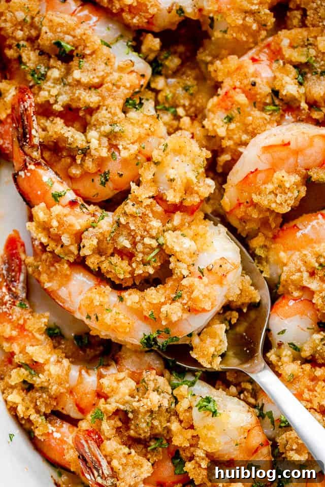 Shrimp Delectables: Garlic Butter Baked and De Jonghe 7 Scooping out Garlic Butter Baked Shrimp with silver spoon.