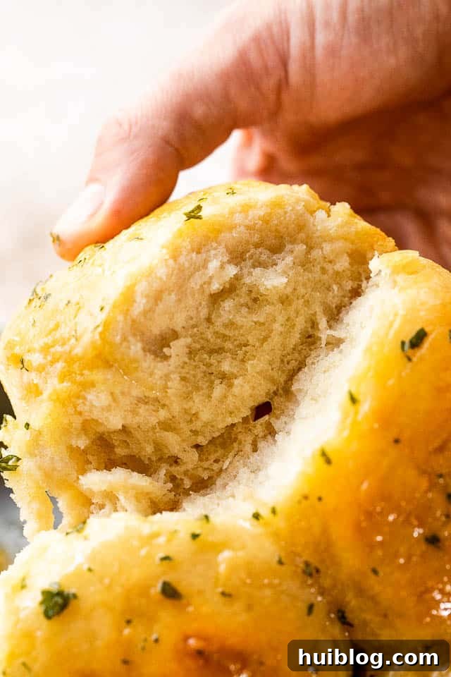 side shot of pulling apart dinner rolls