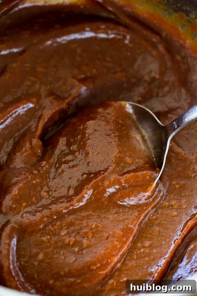Mixing through Apple Butter with silver spoon