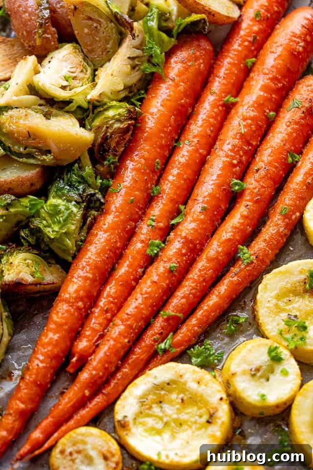 Overhead shot of perfectly roasted whole carrots, glistening with herbs and balsamic, ready to be served.
