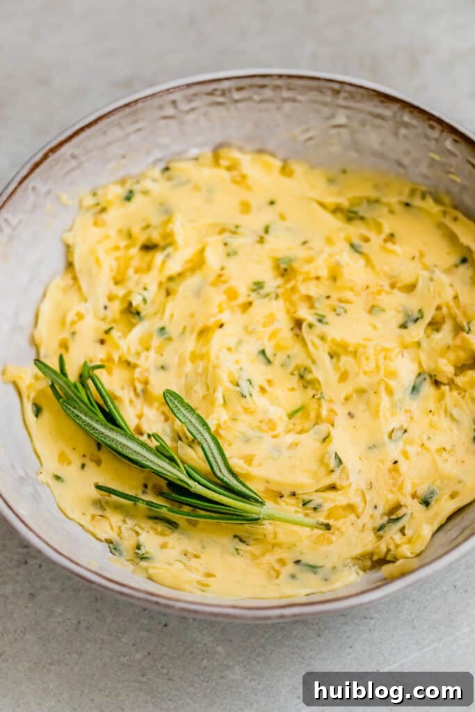 Succulent Roasted Turkey Feast 5 Bowl with butter and fresh rosemary mixed together, ready for turkey preparation.