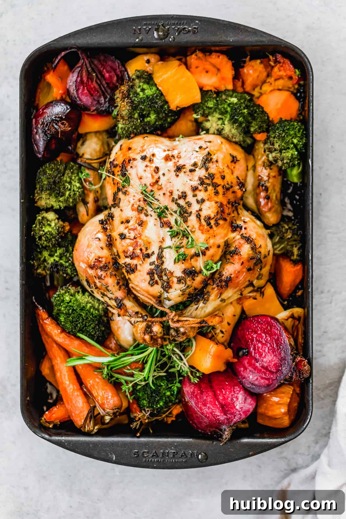 Golden Roasted Chicken and Autumn Harvest Vegetables 6 Whole roast chicken with fall vegetables on a sheet pan.
