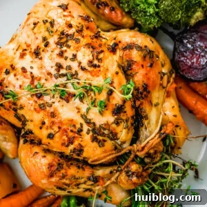 Golden Roasted Chicken and Autumn Harvest Vegetables 8 overhead close up shot of whole roast chicken served on a platter.