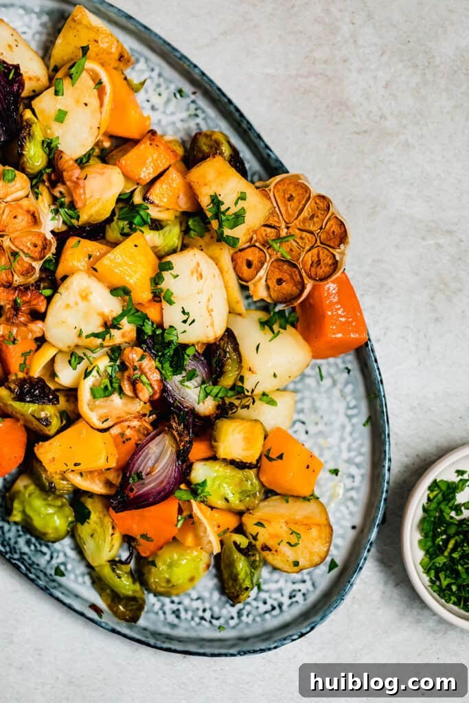 Golden roasted root vegetables on a blue serving platter.