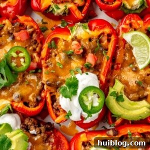 Taco stuffed bell peppers topped with sour cream.