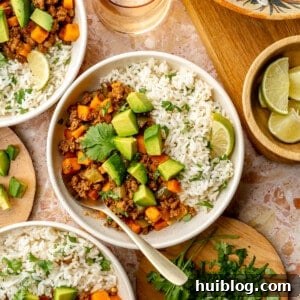 Ground beef and sweet potato served over rice and topped with avocado.