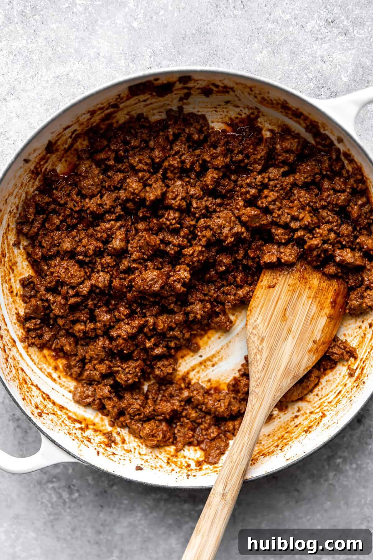 Ground beef taco meat in a white skillet.