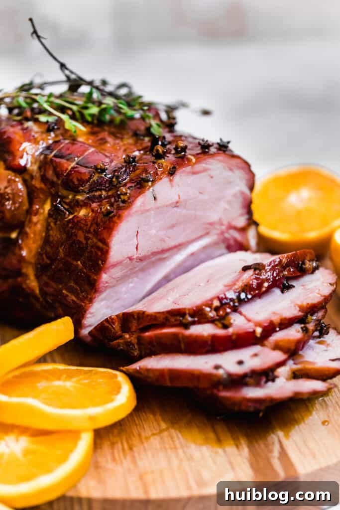 A Glazed Christmas Ham with Four Slices Cut Off, showcasing its succulent interior and caramelized crust.