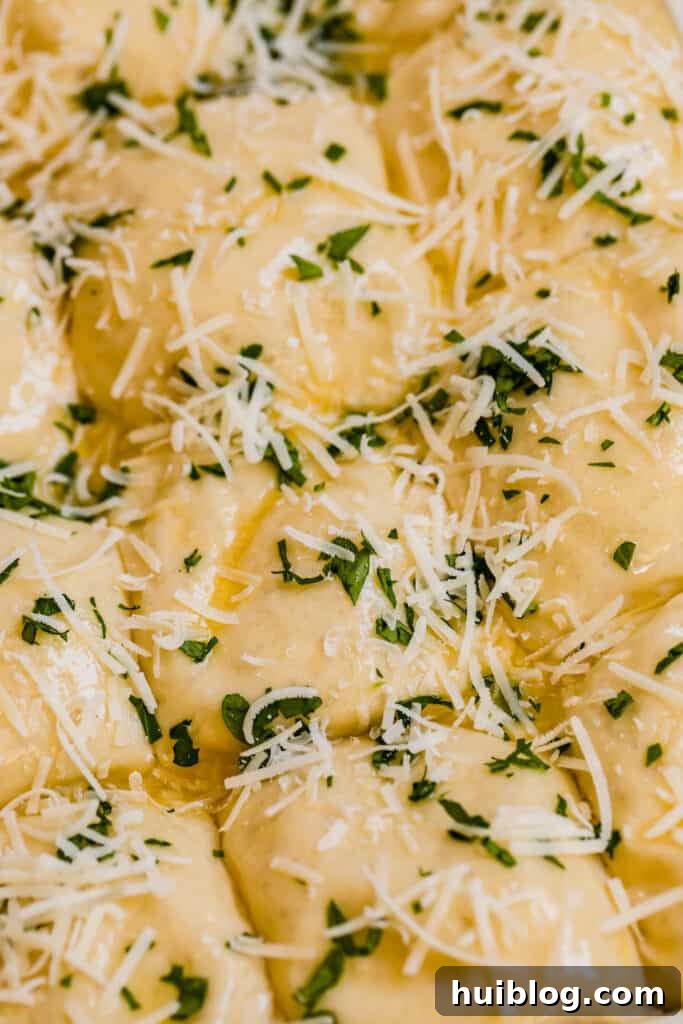 A detailed close-up of cheesy dinner roll dough balls seasoned with vibrant chopped parsley, showcasing the texture before baking.