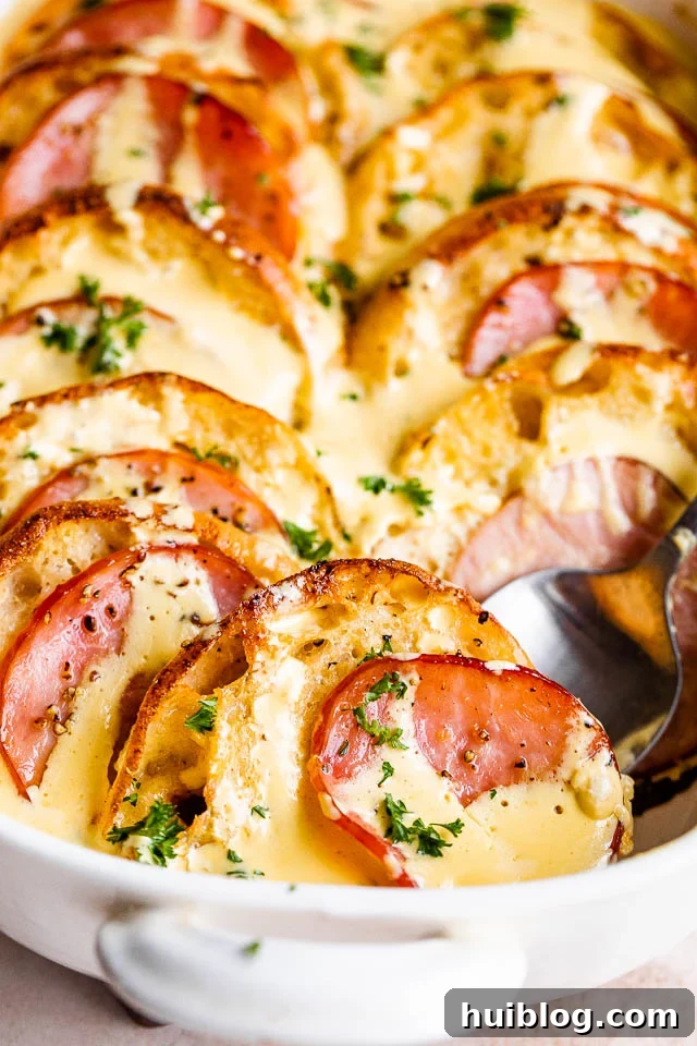 spooning out eggs benedict casserole from a casserole dish