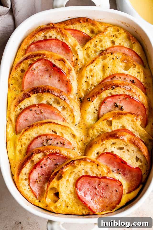 overhead shot of eggs benedict casserole in a white baking dish
