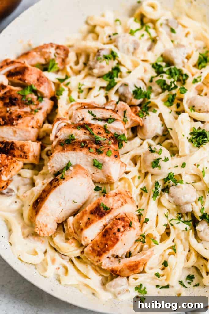 Velvety Chicken Fettuccine Alfredo 3 A Close-Up Shot of Sliced Chicken Breasts and Fettuccine Pasta with Alfredo Sauce