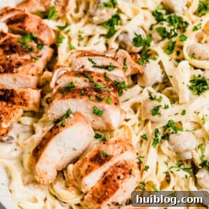 Velvety Chicken Fettuccine Alfredo 5 A Close-Up Shot of Sliced Chicken Breasts and Fettuccine Pasta with Alfredo Sauce
