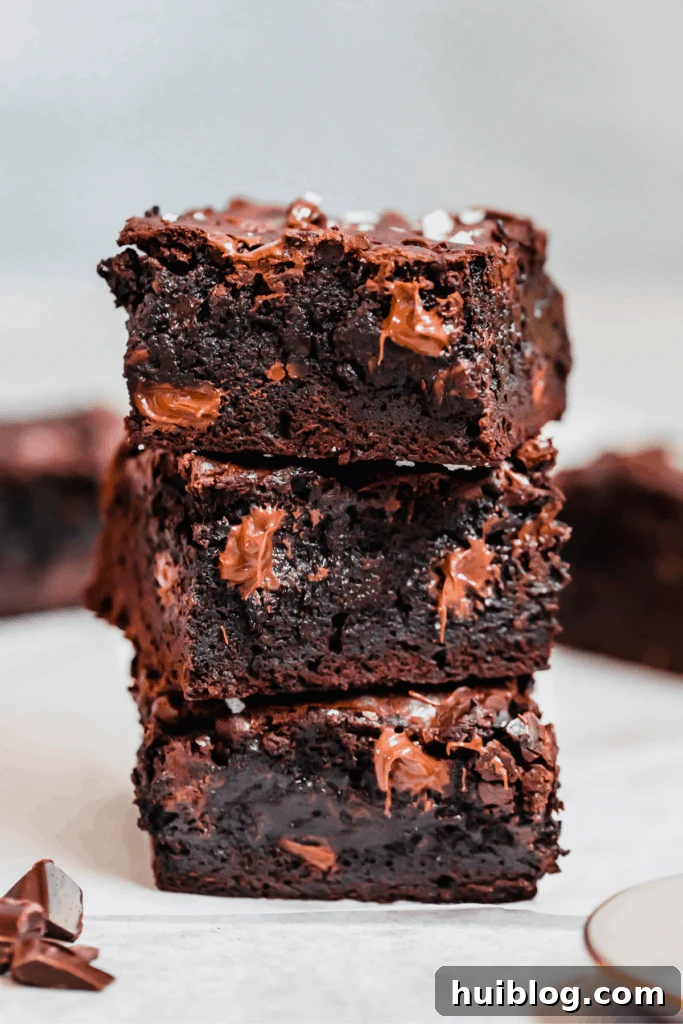 Decadent Homemade Fudge Brownies 2 Stacked fudgy homemade brownies with dark and milk chocolate, garnished with sea salt