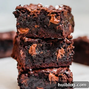 Stacked fudgy homemade brownies with dark and milk chocolate
