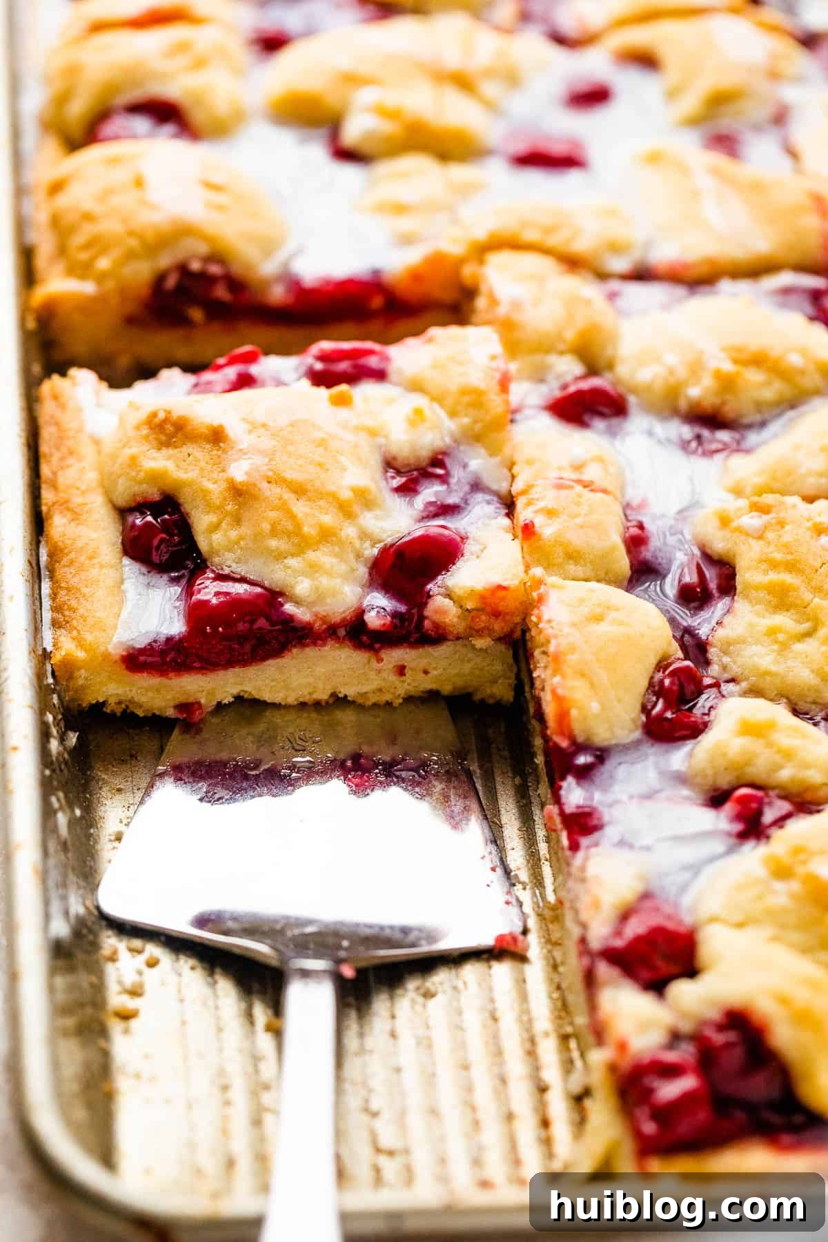 Cherry Kuchen Bars Topped with Glaze, cut into squares ready to serve