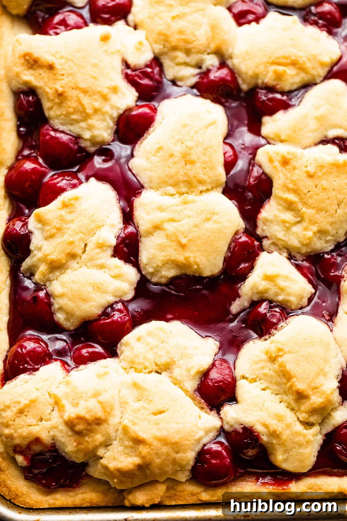 Pan of Cherry Kuchen Bars Topped with Glaze, ready to be sliced