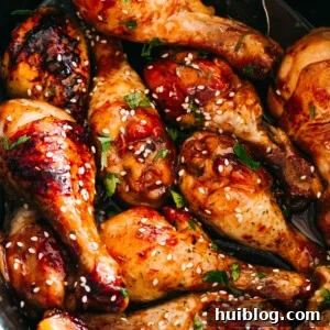close up of chicken drumsticks glazed with honey sriracha sauce
