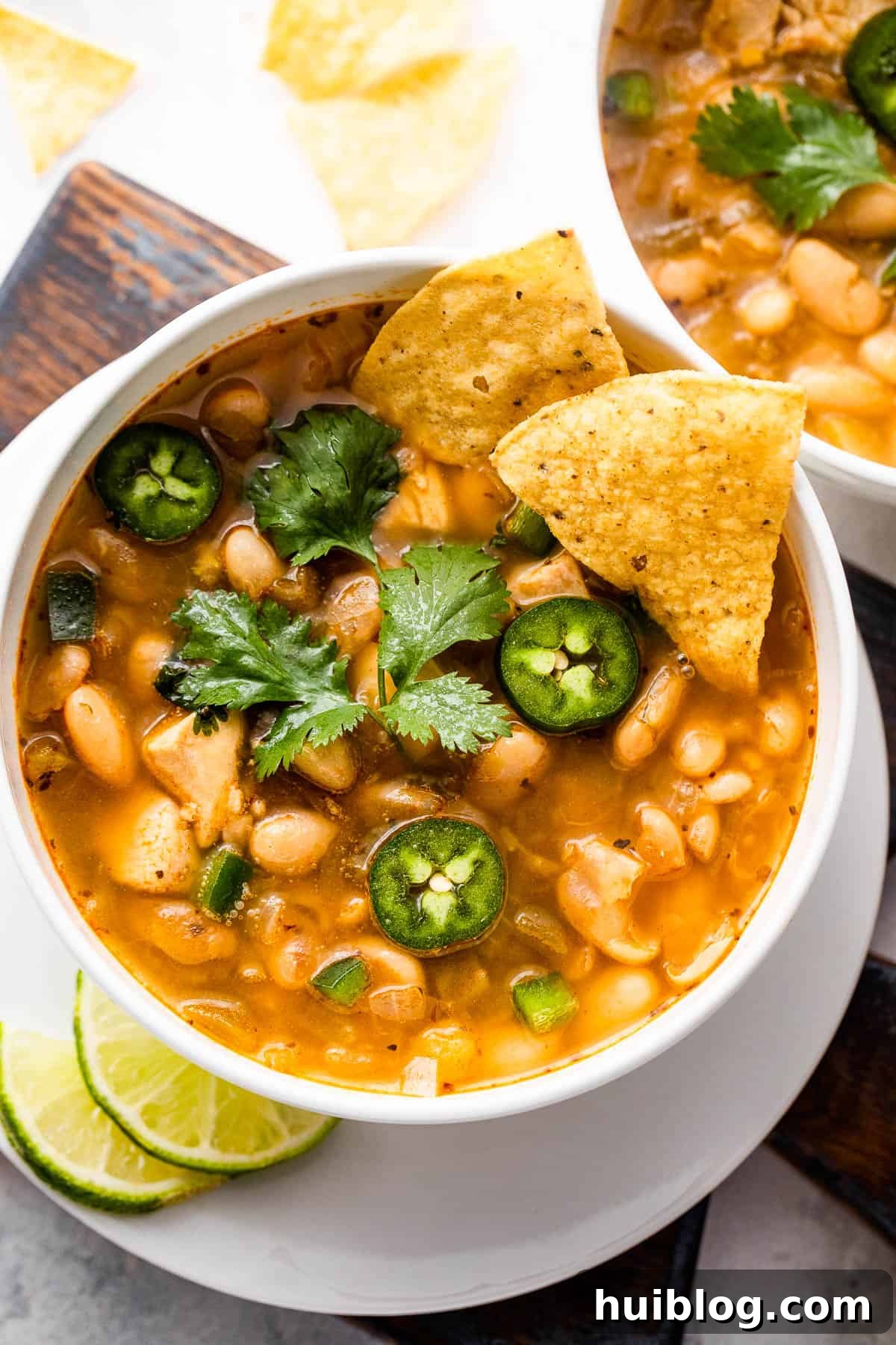 Freshly made Chicken Chili in white bowls, ready to be enjoyed or stored for later.