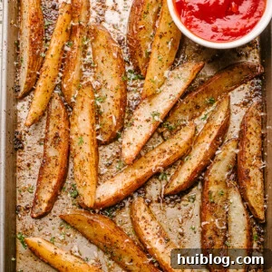 Baking sheet with crispy garlic parmesan potato wedges