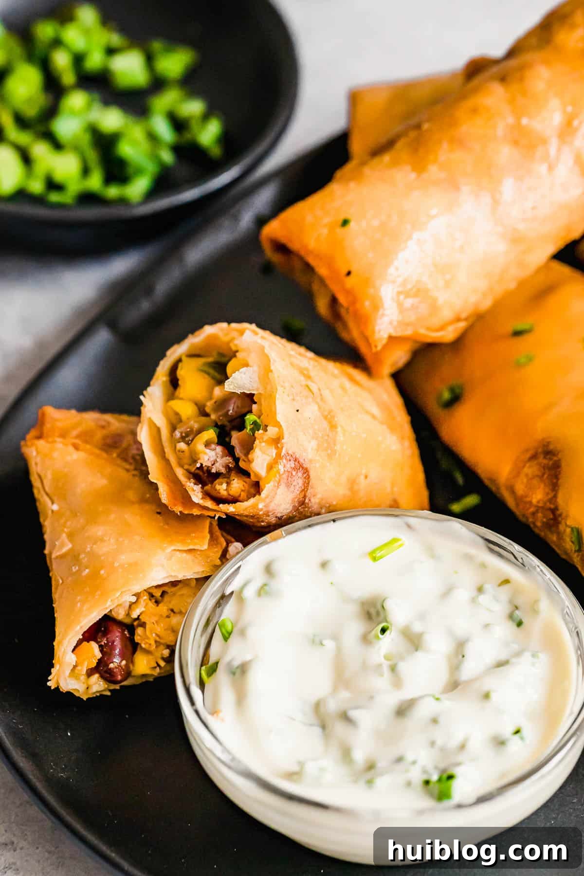 Cheesecake Factory Inspired Tex-Mex Egg Rolls 2 A Plate of Golden Brown Tex Mex Egg Rolls with a Glass Dish of Dipping Sauce