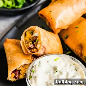 A Plate of Egg Rolls with a Glass Dish of Dipping Sauce
