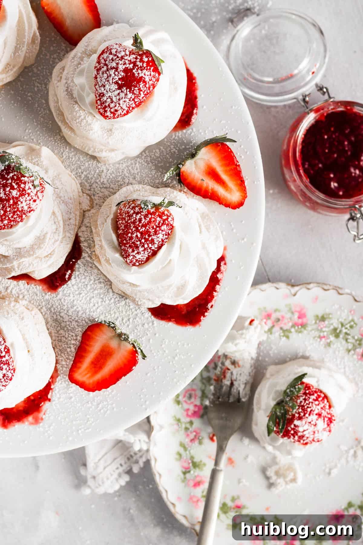 overhead shot of Pavlovas topped with strawberries and sugar