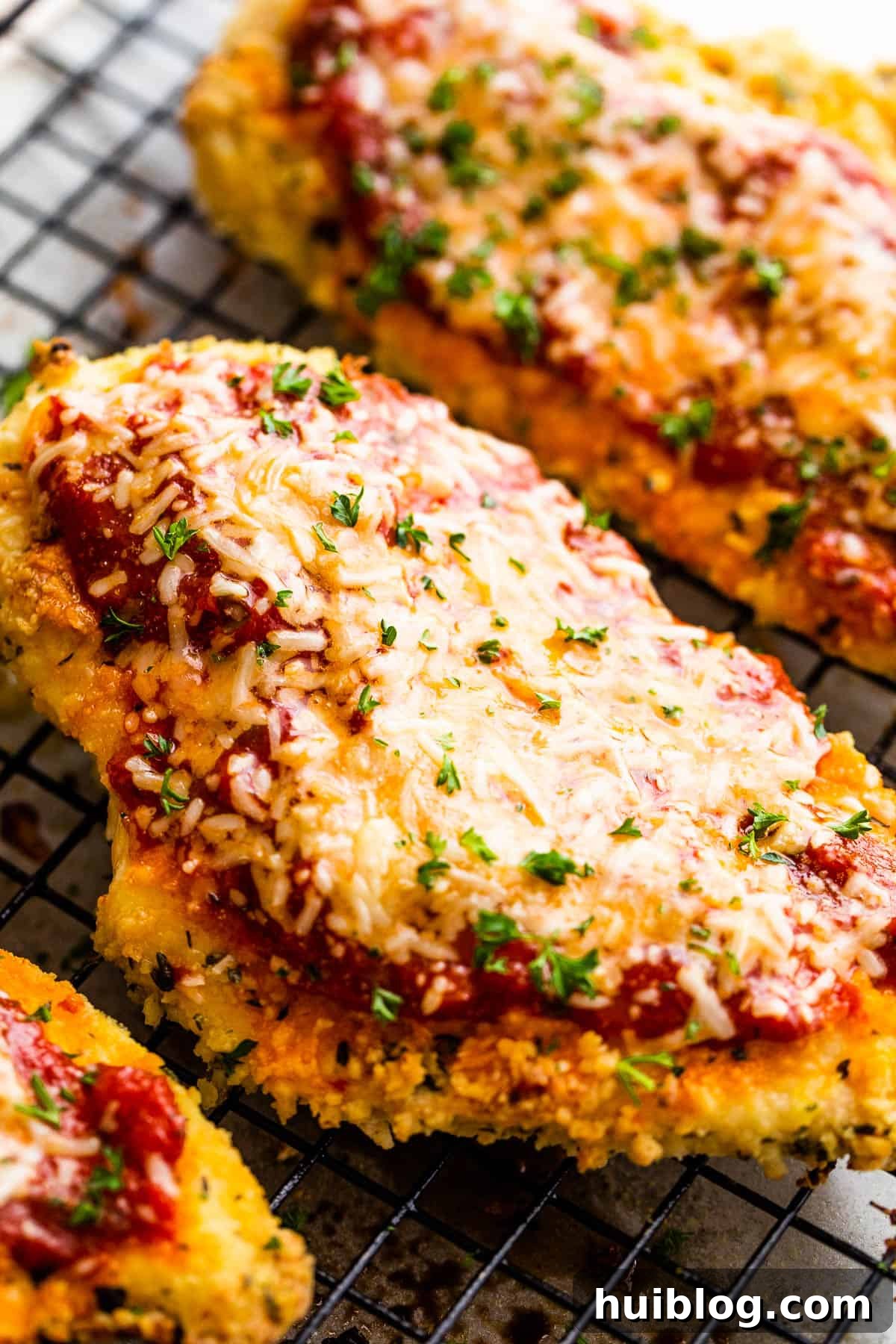 Ultimate Air Fryer Chicken Parmesan 3 A Close-Up Shot of a Piece of Chicken Parmesan on Top of a wire rack