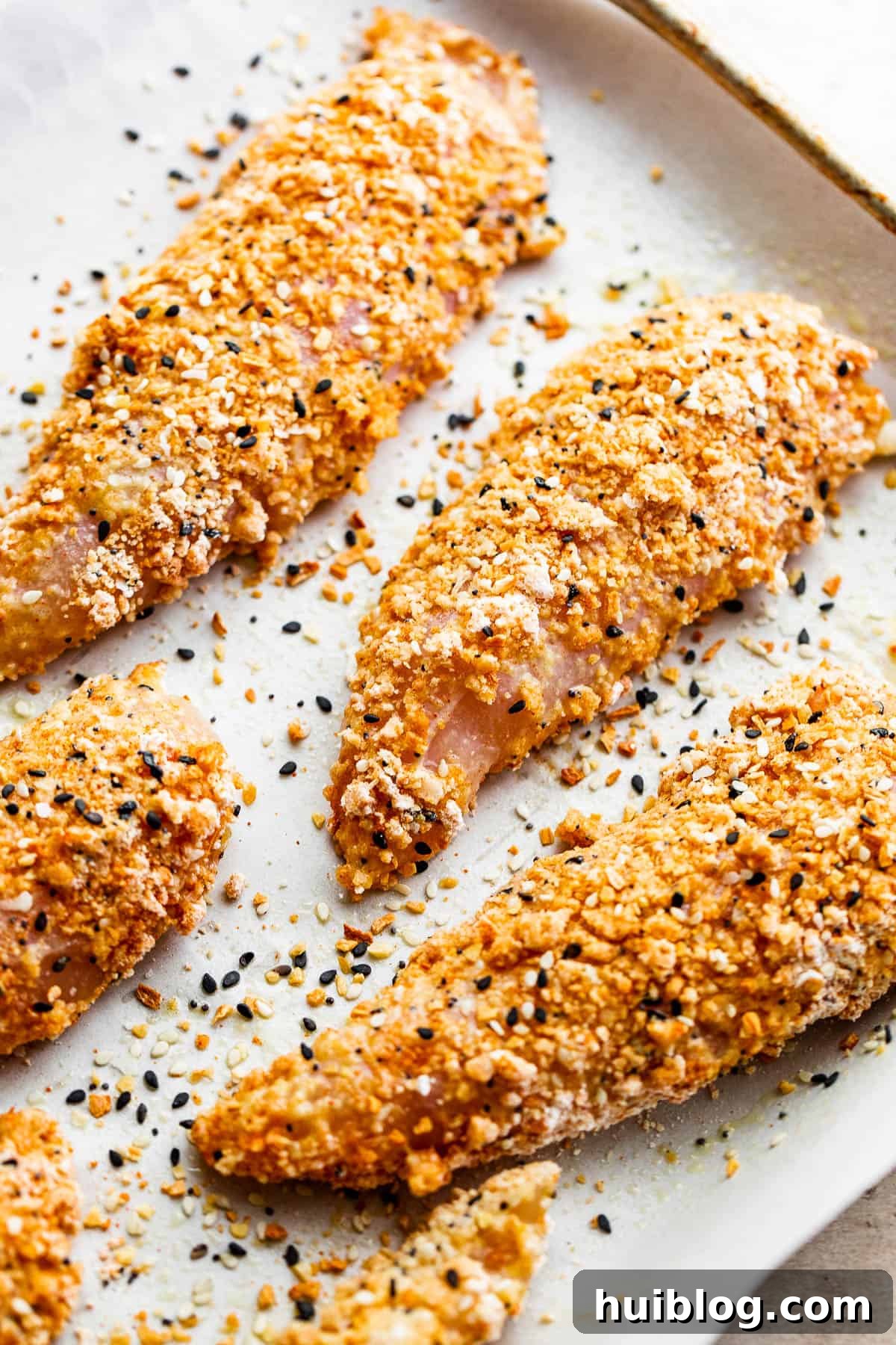 Everything Bagel Crusted Chicken Tenders 5 raw chicken tenders covered with everything bagel seasoning mix