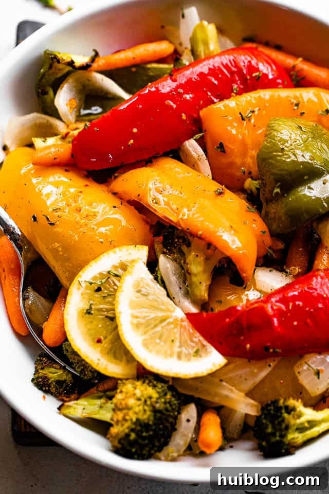 Zesty Grilled Vegetable Medley 2 A bowl of vibrant grilled vegetables garnished with fresh lemon slices, highlighting their smoky, crisp-tender texture and colorful appeal.