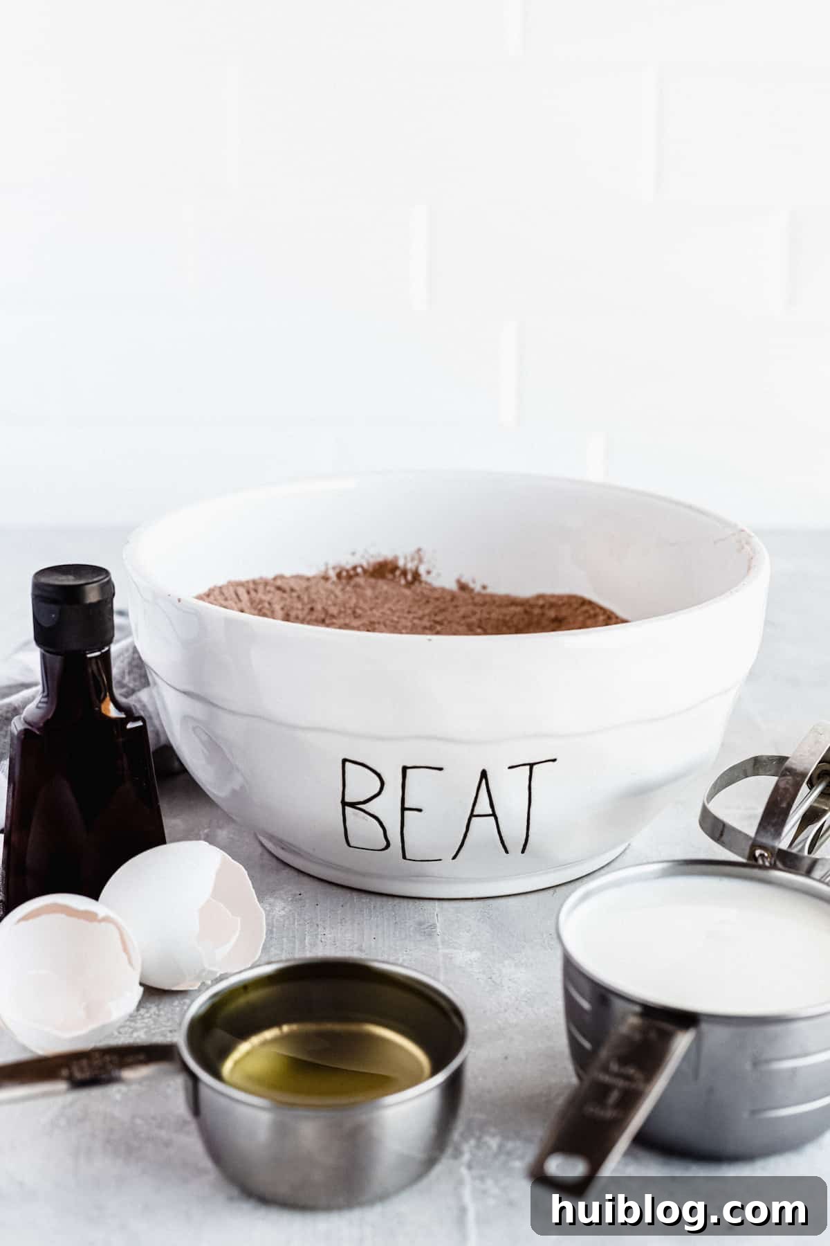 A mixture of the dry ingredients for homemade chocolate cake in a mixing bowl