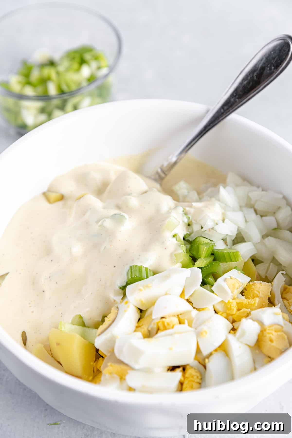All-American Potato Salad 6 Mayonnaise Dressing Added Into the Bowl of Unmixed Potato Salad Ingredients, before stirring.