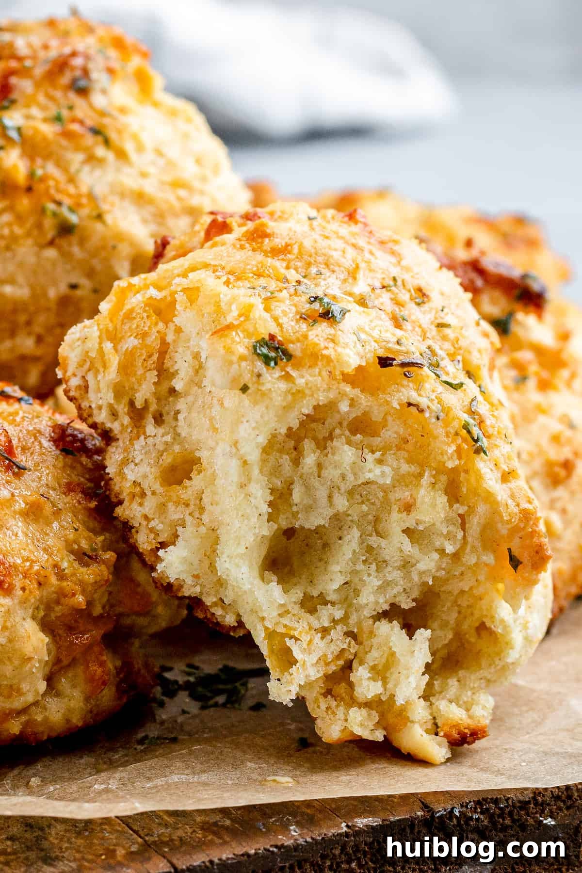 An Air Fryer Red Lobster Biscuit with a bite taken out, revealing its fluffy interior