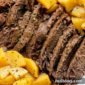 Fork-Tender Instant Pot Pot Roast with Carrots and Potatoes 9 Pot roast with potatoes on a white plate
