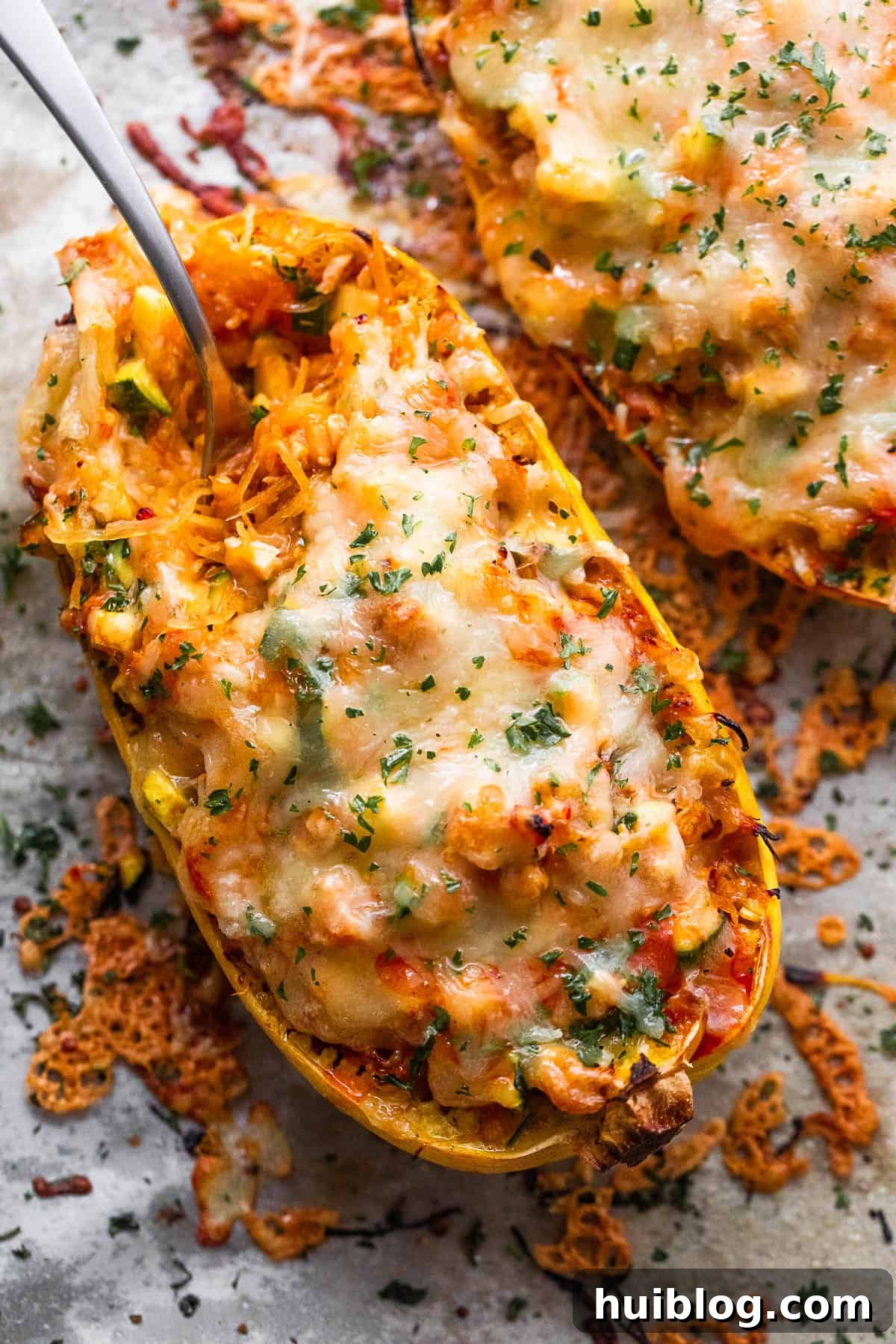Loaded Chicken Enchilada Spaghetti Squash 2 Spaghetti squash stuffed with chicken enchilada filling and topped with melted cheese, ready to serve.