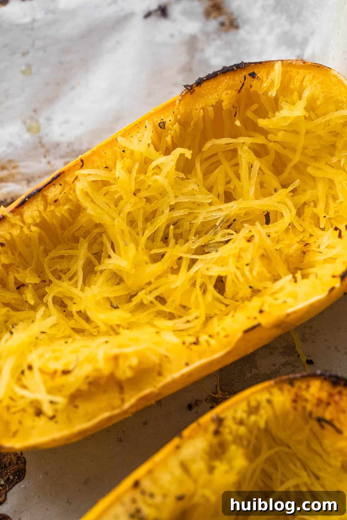 Loaded Chicken Enchilada Spaghetti Squash 4 Spaghetti squash cut in half, showcasing its pale yellow flesh before cooking.