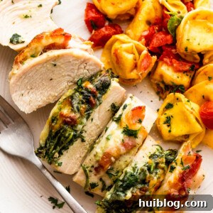 cut up stuffed chicken breast served alongside tortellini pasta