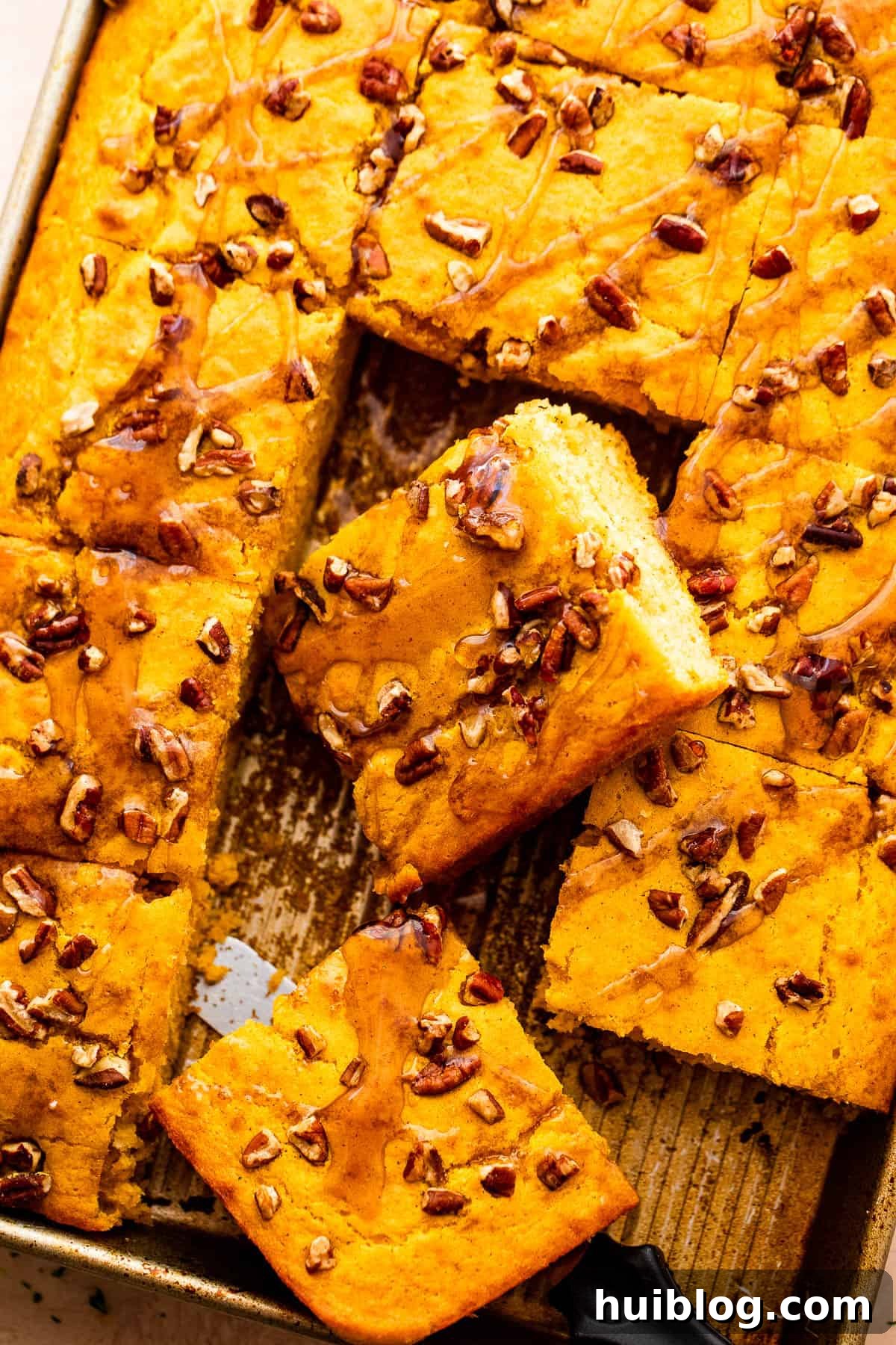 An overhead shot showcasing a full sheet pan of golden, fluffy pumpkin pancakes, ready for serving.