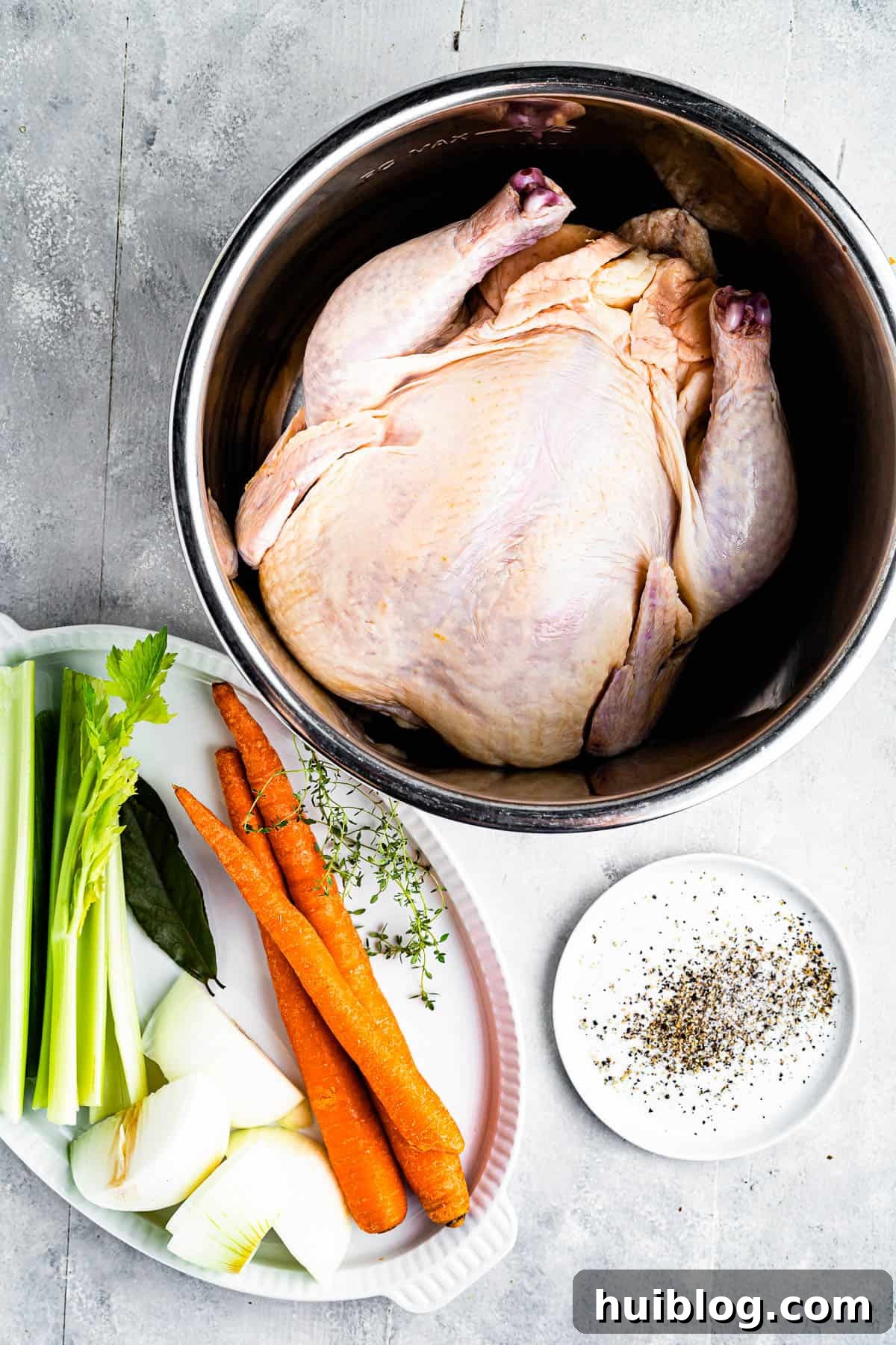 Liquid Gold: Instant Pot Chicken Broth 4 Clockwise from top: a whole chicken in a pot, seasonings, and a tray of raw vegetables including carrots, onions, and celery, laid out as essential ingredients for homemade broth.